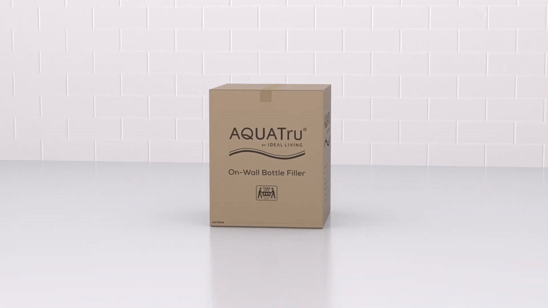 Unboxing water filtration system components, including manual, mounting bracket, drain tube hardware, filter, and QR code installation instructions.
